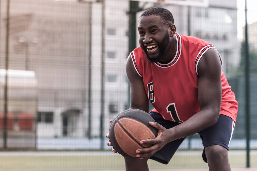 basketball player is playing on basketball court outdoors